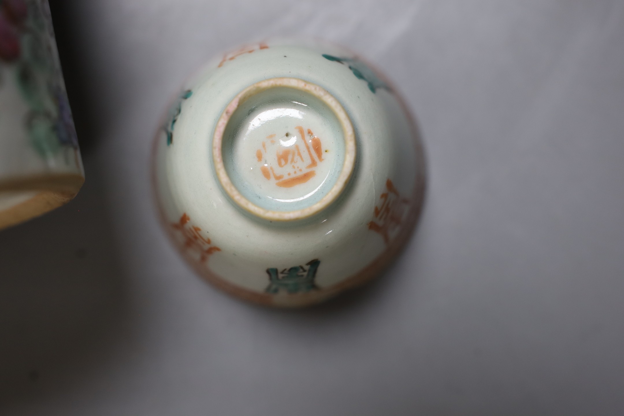 A Chinese teapot and two tea bowls in carrying basket, two Chinese blue figures, and a Chinese enamelled porcelain brush washer, 9.5cm diameter (5)